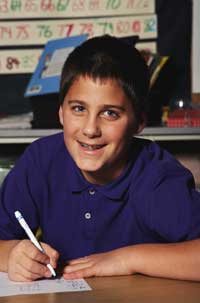 Boy smiling over his homework